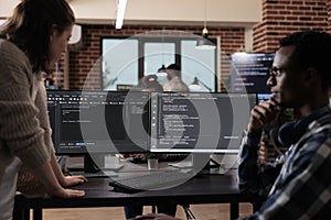 Multiethnic cyber security team members in agency office writing cloud database processing algorithm