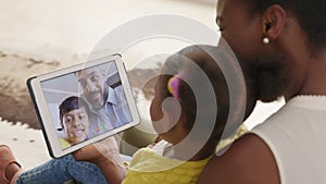 Multiethnic family doing video call using digital tablet