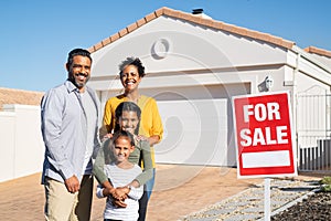 Multiethnic family standing near house sale board