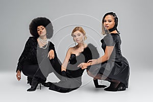 multiethnic fashionistas in black elegant wear photo