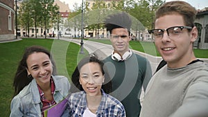 Multiethnic four people taking selfie, talking, smiling, having good day.