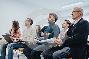 Multiethnic group of businesspeople engaged in a business seminar in modern office.