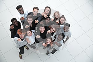 Multiethnic group of five male and female friends hugging and lo