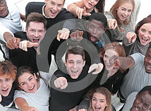 multiethnic group of five male and female friends hugging and lo