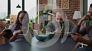 Multiethnic group of friends meeting at home to use smartphones