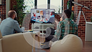 Multiethnic group of friends watching movie on tv channel