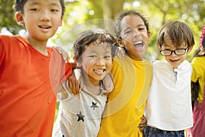 Multiethnic group of school children laughing and embracing
