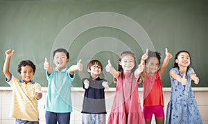 Multiethnic group of school children standing in classroom
