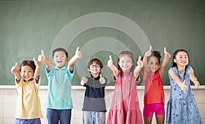 Multiethnic group of school children standing in classroom
