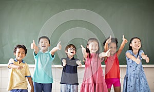 Multiethnic group of school children standing in classroom