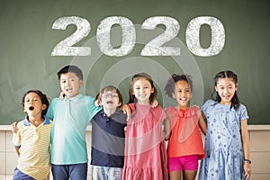 Multiethnic group of school children standing in classroom