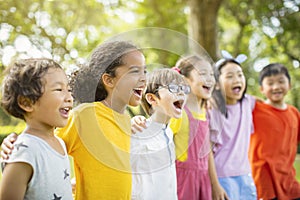 Multiethnic group of school kids laughing and embracing