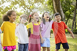 Multiethnic group of school kids laughing and embracing