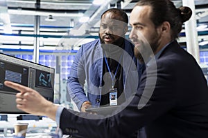 Multiethnic group of solar energy experts and technicians evaluates system