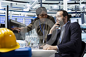 Multiethnic group of solar energy experts and technicians evaluates system