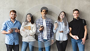 Multiethnic group of university students against college wall photo