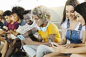 Multiethnic group of young friends using mobile phone