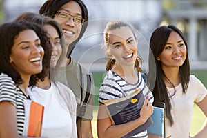 Multiethnic group of young happy students standing outdoors.