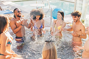 Multiethnic group of young people. mixed race best friends having fun in jacuzzi