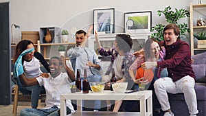 Multiethnic group of young people watching basketball game on TV at home