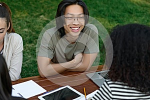 Multiethnic group of young students sitting and studying