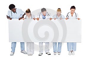 Multiethnic medical team looking at blank billboard