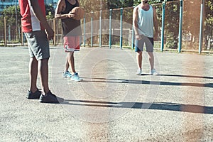 Multiethnic men playing basketball on court