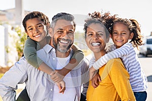 Multiethnic parents giving children piggyback ride