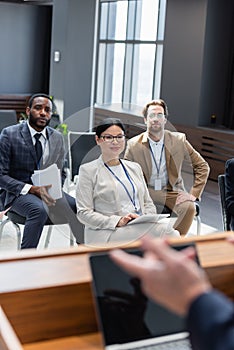 multiethnic participants listening to speaker during