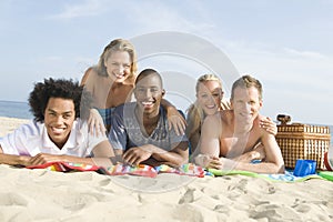 Multiethnic People Lying On Sand