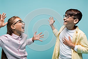 Multiethnic schoolkids in eyeglasses having fun