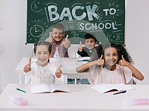 Multiethnic schoolkids with thumbs up