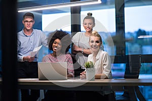 Multiethnic startup business team in night office