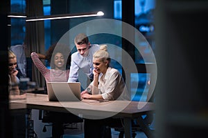 Multiethnic startup business team in night office