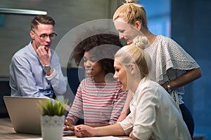 Multiethnic startup business team in night office