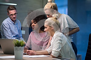 Multiethnic startup business team in night office