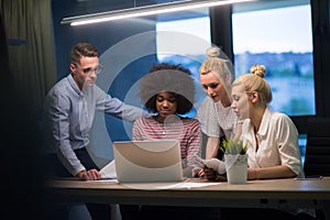 Multiethnic startup business team in night office