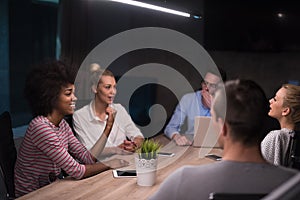 Multiethnic startup business team in night office