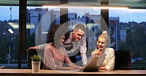 Multiethnic startup business team in night office photo