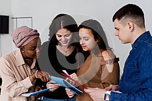 Multiethnic students and teacher study foreign languages together in class. Studing with notebook. Black attractive girl