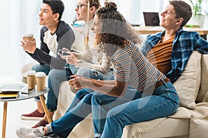 multiethnic teen girls playing video game