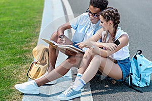 multiethnic teenage boy and girl studying together