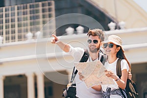 Multiethnic traveler couple using generic local map together on sunny day. Honeymoon trip, backpacker tourist, Asia tourism