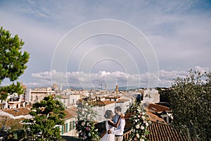 Multiethnic wedding couple. Destination fine-art wedding in Florence, Italy. A wedding ceremony on the roof of the