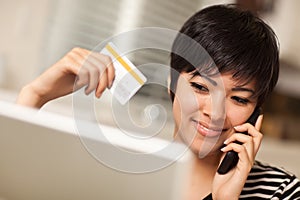 Multiethnic Woman with Phone, Credit Card, Laptop