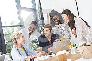 multiethnic young business team working on laptop together at workplace