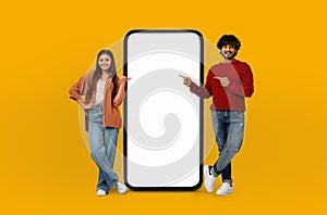 Multiethnic Young Lovers Standing Next to Large Phone