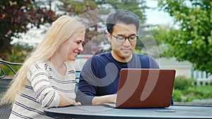 Multiethnicity young friends working with laptop.