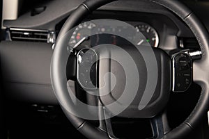 Multifunction steering wheel in leather car interior at night