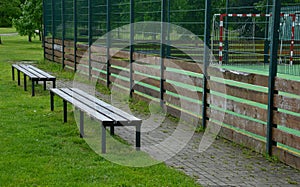 Multifunctional outdoor playground for ball games at school. green artificial turf from a plastic carpet with lines. basketball ho